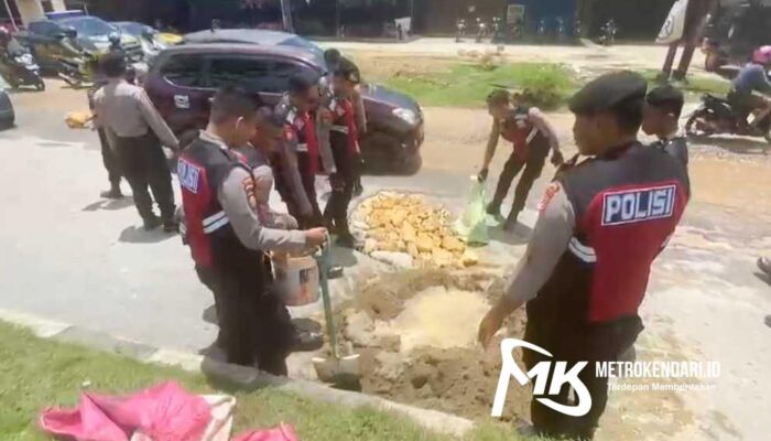 Personel Polda Sultra Gotong Royong Benahi Jalan Rusak di Depan SPBU Martandu